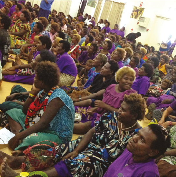 Large group of women sitting on floor during meeting