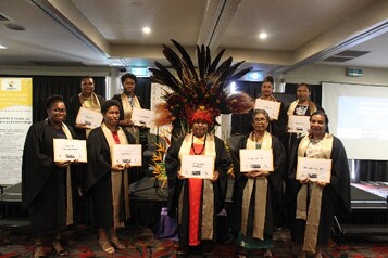 Cohort 11 graduates pose for a group photo